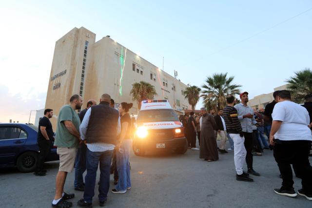 (261023) -- KARAK, Oct. 23, 2026 (Xinhua) -- People gather outside a hospital in Karak after a shooting attack in Jordan's southern governorate of Karak, Oct. 23, 2026. Seven people were killed and 34 others injured in a shooting attack during a funeral in Jordan's southern governorate of Karak, the Jordanian Public Security Directorate said Friday. (Photo by Mohammad Abu Ghosh/Xinhua)