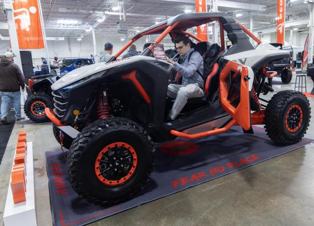 (261024) -- MISSISSAUGA, Oct. 24, 2026 (Xinhua) -- A man checks out a Segway utility task vehicle at the 2026 Toronto International Snowmobile, ATV & Powersports Show in Mississauga, Canada, on Oct. 23, 2026. Showcasing hundreds of snowmobiles and powersports vehicles from major manufacturers worldwide, the annual event runs here from Friday to Sunday. (Photo by Zou Zheng/Xinhua)