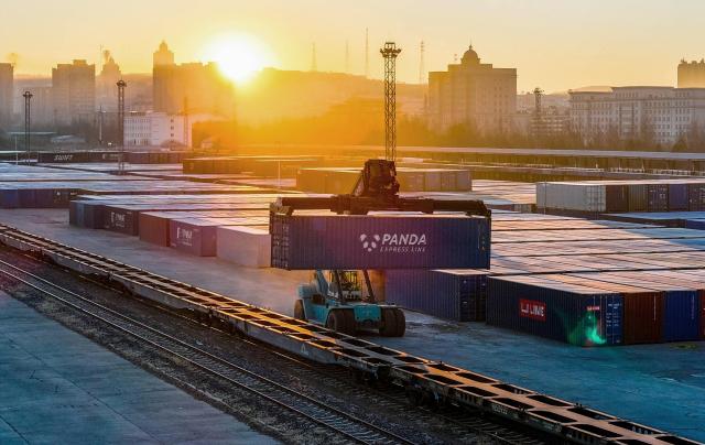 (261024) -- BEIJING, Oct. 24, 2026 (Xinhua) -- A drone photo taken on Oct. 23, 2026 shows a vehicle transferring a container during transshipment of an inbound China-Europe freight train at Suifenhe Railway Station in Suifenhe, northeast China's Heilongjiang Province. According to China Railway Harbin Group, a total of 6,024 China-Europe freight train trips have been made via the eastern corridor of the China-Europe freight train service so far this year, up 40.3 percent year on year. (Photo by Qu Yiwei/Xinhua)