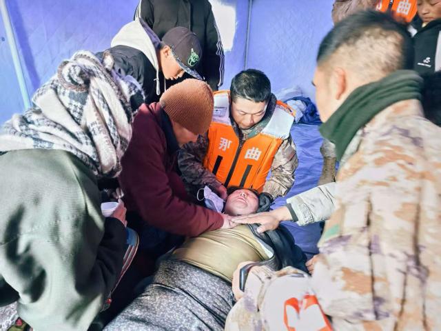 (261024) -- NAGQU, Oct. 24, 2026 (Xinhua) -- Members of the People's Armed Police Force Xizang Corps provide medical treatment to a villager at a quake-hit village in Maru Township of Baqen County, Nagqu City, southwest China's Xizang Autonomous Region, Oct. 23, 2026.
  Sixteen people have been killed and 76 others are injured following a 7.0-magnitude earthquake that struck Baqen County of the city of Nagqu in southwest China's Xizang Autonomous Region at 10:33 p.m. on Thursday, local authorities said. (Photo by Wang Jianing/Xinhua)