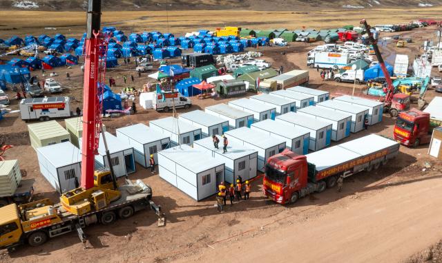 (261024) -- NAGQU, Oct. 24, 2026 (Xinhua) -- A drone photo taken on Oct. 24, 2026 shows workers of China Railway Group Limited building prefabricated houses at a quake-hit village in Maru Township of Baqen County, Nagqu City, southwest China's Xizang Autonomous Region.
  The first batch of prefabricated houses has been set up on Saturday for the affected residents in a village of Maru Township, one of the hardest-hit areas near the epicenter, following a 7.0-magnitude earthquake that struck Baqen County of the city of Nagqu in southwest China's Xizang Autonomous Region at 10:33 p.m. on Thursday. (Xinhua/Tenzin Nyida)
