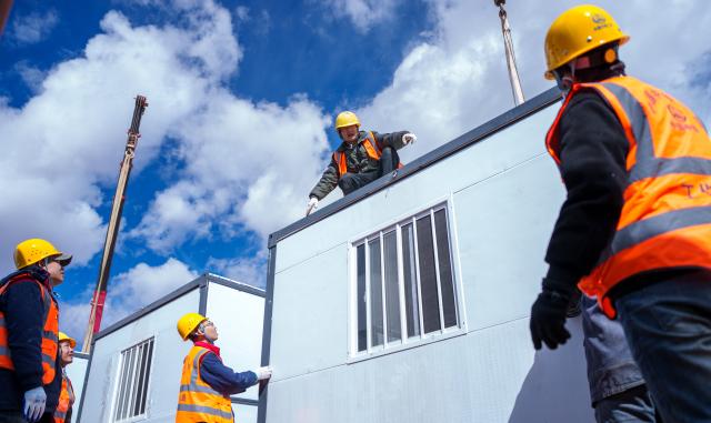(261024) -- NAGQU, Oct. 24, 2026 (Xinhua) -- Workers of China Railway Group Limited build a prefabricated house at a quake-hit village in Maru Township of Baqen County, Nagqu City, southwest China's Xizang Autonomous Region, Oct. 24, 2026.
  The first batch of prefabricated houses has been set up on Saturday for the affected residents in a village of Maru Township, one of the hardest-hit areas near the epicenter, following a 7.0-magnitude earthquake that struck Baqen County of the city of Nagqu in southwest China's Xizang Autonomous Region at 10:33 p.m. on Thursday. (Xinhua/Tenzin Nyida)