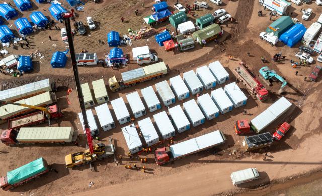 (261024) -- NAGQU, Oct. 24, 2026 (Xinhua) -- An aerial drone photo taken on Oct. 24, 2026 shows workers of China Railway Group Limited building prefabricated houses at a quake-hit village in Maru Township of Baqen County, Nagqu City, southwest China's Xizang Autonomous Region.
  The first batch of prefabricated houses has been set up on Saturday for the affected residents in a village of Maru Township, one of the hardest-hit areas near the epicenter, following a 7.0-magnitude earthquake that struck Baqen County of the city of Nagqu in southwest China's Xizang Autonomous Region at 10:33 p.m. on Thursday. (Xinhua/Tenzin Nyida)