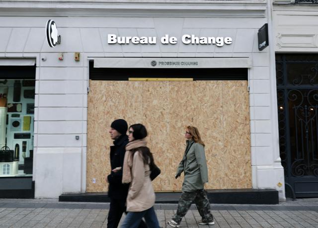 (261024) -- PARIS, Oct. 24, 2026 (Xinhua) -- People walk past a boarded-up shop on the Avenue Champs-Elysees in Paris, France, Oct. 24, 2026. French Interior Minister Laurent Nunez said Tuesday that the government would deploy soldiers from the French army's Operation Sentinelle to help prevent violence during the demonstrations announced for Oct. 24. (Xinhua/Wu Huiwo)