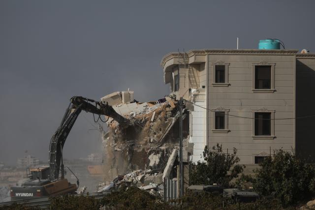 (261024) -- HEBRON, Oct. 24, 2026 (Xinhua) -- A bulldozer demolishes a residential building near the northern entrance of the West Bank city of Hebron, on Oct. 23, 2026. Israel is preparing a major military operation in the West Bank, Israeli Prime Minister Benjamin Netanyahu said Friday, as local sources said Israeli forces demolished a residential building in Hebron and closed the city's main entrances following a shooting attack that killed two Israeli soldiers and two Palestinian attackers. (Photo by Mamoun Wazwaz/Xinhua)