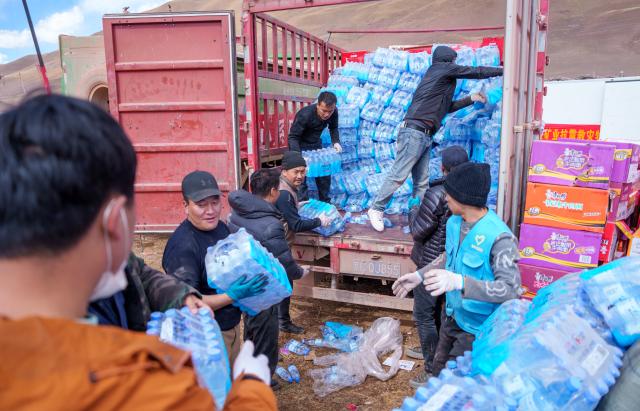 (261024) -- NAGQU, Oct. 24, 2026 (Xinhua) -- Staff members transfer bottled water at a quake-hit village in Maru Township of Baqen County, Nagqu City, southwest China's Xizang Autonomous Region, Oct. 24, 2026. As of 11 a.m. Saturday, 52,450 items or sets of disaster relief supplies had been sent to the quake zone, while more than 2,500 rescue personnel were engaged in relief operations.
   Authorities have established 35 temporary resettlement sites in the disaster zone. Medical treatment and public health and epidemic prevention efforts are proceeding in an orderly manner, according to the local emergency command headquarters. (Xinhua/Tenzin Nyida)