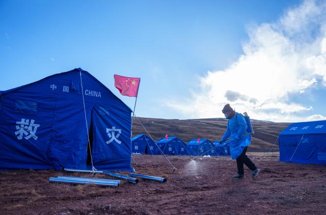 (261024) -- NAGQU, Oct. 24, 2026 (Xinhua) -- A staff member sanitizes the tents area at a quake-hit village in Maru Township of Baqen County, Nagqu City, southwest China's Xizang Autonomous Region, Oct. 24, 2026. As of 11 a.m. Saturday, 52,450 items or sets of disaster relief supplies had been sent to the quake zone, while more than 2,500 rescue personnel were engaged in relief operations.
   Authorities have established 35 temporary resettlement sites in the disaster zone. Medical treatment and public health and epidemic prevention efforts are proceeding in an orderly manner, according to the local emergency command headquarters. (Xinhua/Tenzin Nyida)