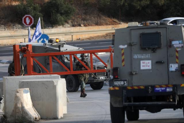 (261024) -- HEBRON, Oct. 24, 2026 (Xinhua) -- Israeli military forces are seen at an Israeli military checkpoint near the northern entrance to Hebron City, in the West Bank, on Oct. 24, 2026. Israeli forces launched a military operation in the West Bank city of Hebron on Friday night, hours after Israeli leaders vowed to displace residents and carry out demolitions following a shooting attack near the city that killed two Israeli soldiers.
  Prime Minister Benjamin Netanyahu also vowed to expand military operations and demolitions in Hebron, four days before Israel's parliamentary election. (Photo by Mamoun Wazwaz/Xinhua)
