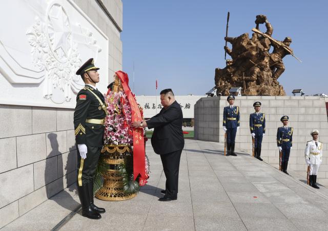 (261024) -- DANDONG, Oct. 24, 2026 (Xinhua) -- Kim Jong Un, general secretary of the Workers' Party of Korea and president of the State Affairs of the Democratic People's Republic of Korea (DPRK), presents a flower basket to the memorial tower at the square of the Memorial Hall of the War to Resist U.S. Aggression and Aid Korea, in Dandong, northeast China's Liaoning Province, Oct. 24, 2026. Wang Huning, a member of the Standing Committee of the Political Bureau of the Communist Party of China (CPC) Central Committee and chairman of the National Committee of the Chinese People's Political Consultative Conference, on Saturday accompanied Kim on a visit to Dandong in northeast China's Liaoning Province and conveyed General Secretary of the CPC Central Committee and Chinese President Xi Jinping's cordial greetings and best wishes to Kim. (Xinhua/Yao Dawei)