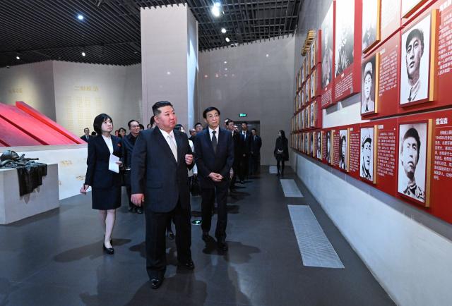 (261024) -- DANDONG, Oct. 24, 2026 (Xinhua) -- Wang Huning, a member of the Standing Committee of the Political Bureau of the Communist Party of China (CPC) Central Committee and chairman of the National Committee of the Chinese People's Political Consultative Conference, accompanies Kim Jong Un, general secretary of the Workers' Party of Korea and president of the State Affairs of the Democratic People's Republic of Korea (DPRK), to visit the Memorial Hall of the War to Resist U.S. Aggression and Aid Korea in Dandong, northeast China's Liaoning Province, Oct. 24, 2026. Wang on Saturday accompanied Kim on a visit to Dandong in northeast China's Liaoning Province and conveyed General Secretary of the CPC Central Committee and Chinese President Xi Jinping's cordial greetings and best wishes to Kim. (Xinhua/Rao Aimin)