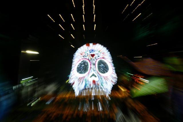 (261024) -- MEXICO CITY, Oct. 24, 2026 (Xinhua) -- This photo taken on Oct. 23, 2026 shows a skull-shaped light art installation along Paseo de la Reforma in Mexico City, capital of Mexico. As the Day of the Dead approaches, giant light sculptures along Paseo de la Reforma in Mexico City, capital of Mexico, are illuminated. (Photo by Francisco Canedo/Xinhua)