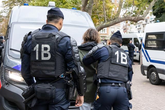(261024) -- LILLE, Oct. 24, 2026 (Xinhua) -- Security personnel take away a protester in Lille, France, Oct. 24, 2026. Around 410,000 people took part in a new round of protests across France on Saturday, French news channel BFM TV reported, citing the Interior Ministry. (Photo by Sebastien Courdji/Xinhua)