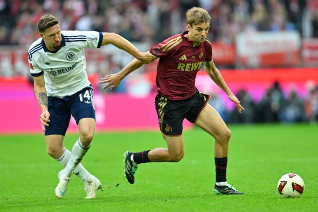 (261025) -- COLOGNE, Oct. 25, 2026 (Xinhua) -- Borna Sosa (R) of FC Cologne vies with Janik Bachmann of FC Schalke 04 during the German first division Bundesliga football match between FC Cologne and FC Schalke 04 in Cologne, Germany, Oct. 24, 2026. (Photo by Ulrich Hufnagel/Xinhua)