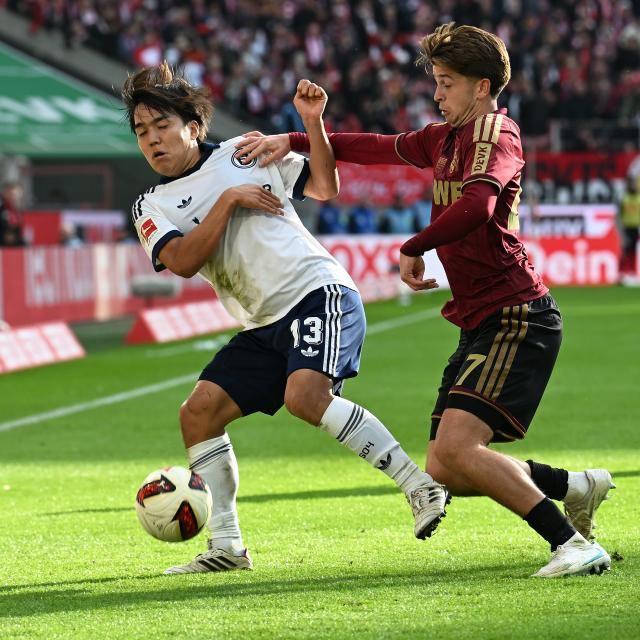 (261025) -- COLOGNE, Oct. 25, 2026 (Xinhua) -- Mikey Moore (R) of FC Cologne vies with Tanaka Satoshi of FC Schalke 04 during the German first division Bundesliga football match between FC Cologne and FC Schalke 04 in Cologne, Germany, Oct. 24, 2026. (Photo by Ulrich Hufnagel/Xinhua)