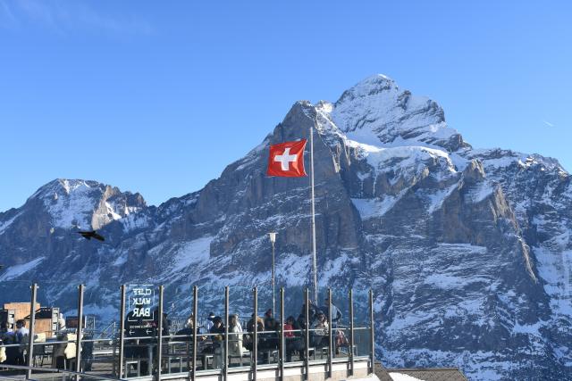 (261025) -- GENEVA, Oct. 25, 2026 (Xinhua) -- This file photo shows tourists viewing the Eiger on a viewing platform at Grindelwald-First mountain in the canton of Bern, Switzerland, Dec. 18, 2025. TO GO WITH "Feature: Taste of China's Wuyi Mountain at Switzerland's Grindelwald-First" (Xinhua/Lian Yi)