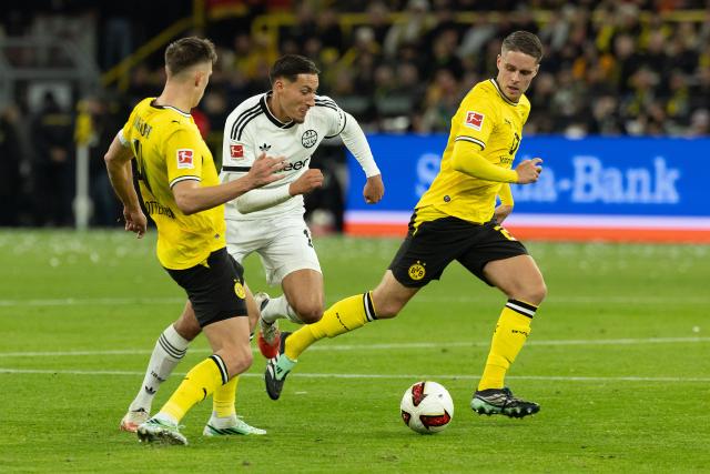 (261025) -- DORTMUND, Oct. 25, 2026 (Xinhua) -- Nico Schlotterbeck (L), Joey Veerman (R) of Borussia Dortmund vie with Younes Ebnoutalib of Eintracht Frankfurt during the German first division Bundesliga football match between Borussia Dortmund and Eintracht Frankfurt in Dortmund, Germany, Oct. 24, 2026. (Photo by Joachim Bywaletz/Xinhua)