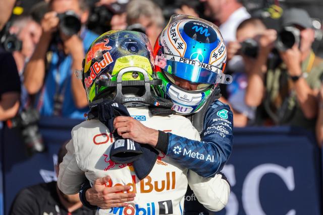 (261025) -- AUSTIN, Oct. 25, 2026 (Xinhua) -- Mercedes' Kimi Antonelli (R) of Italy hugs with Red Bull Racing's Isack Hadjar of France after the qualifying session of the Formula One United States Grand Prix, in Austin, Texas, the United States, Oct. 24, 2026. (Photo by Xu Mingnan/Xinhua)