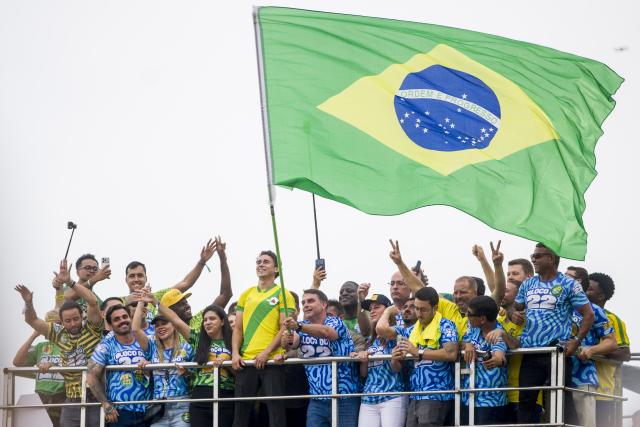 (261025) -- RIO DE JANEIRO, Oct. 25, 2026 (Xinhua) -- Brazilian Senator Flavio Bolsonaro (C), presidential candidate of Brazil's Liberal Party, waves a Brazilian national flag during a presidential campaign rally in Rio de Janeiro, Brazil, Oct. 24, 2026. Brazilian incumbent President and presidential candidate of Brazil's ruling Workers' Party Luiz Inacio Lula da Silva, and presidential candidate of Brazil's Liberal Party Flavio Bolsonaro held the last campaign rally on Saturday in Sao Paulo and Rio de Janeiro, respectively. The second round of voting for Brazil's 2026 presidential election will be held on Sunday. (Photo by Daniel Ramalho/Xinhua)