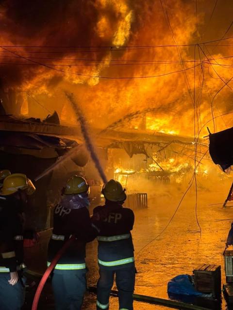 (261025) -- SORSOGON, Oct. 25, 2026 (Xinhua) -- Firefighters try to put out a fire at a public market in Sorsogon city of southern Luzon, the Philippines, on Oct. 25, 2026. Five people have been confirmed dead after a fire in a public market here on Saturday night, local media reported Sunday. (The Philippines' Bureau of Fire Protection/Handout via Xinhua)