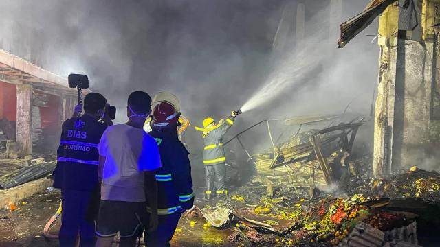 (261025) -- SORSOGON, Oct. 25, 2026 (Xinhua) -- Firefighters try to put out a fire at a public market in Sorsogon city of southern Luzon, the Philippines, on Oct. 25, 2026. Five people have been confirmed dead after a fire in a public market here on Saturday night, local media reported Sunday. (Sorsogon Public Information Office/Handout via Xinhua)