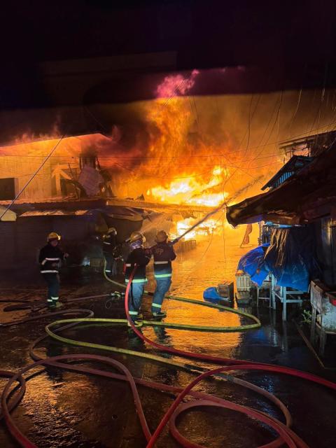 (261025) -- SORSOGON, Oct. 25, 2026 (Xinhua) -- Firefighters try to put out a fire at a public market in Sorsogon city of southern Luzon, the Philippines, on Oct. 25, 2026. Five people have been confirmed dead after a fire in a public market here on Saturday night, local media reported Sunday. (The Philippines' Bureau of Fire Protection/Handout via Xinhua)
