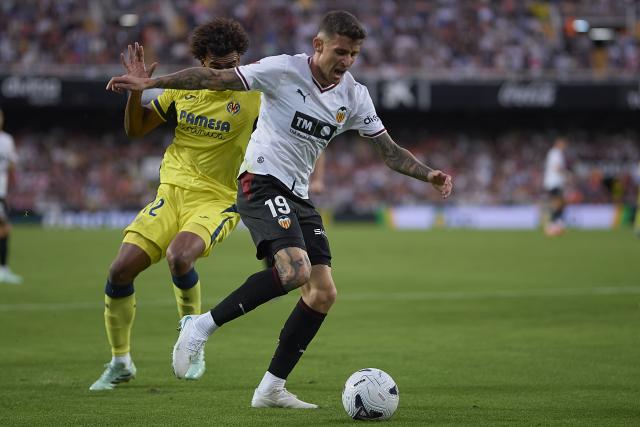 (261025) -- VALENCIA, Oct. 25, 2026 (Xinhua) -- Dani Raba (R) of Valencia competes for the ball with Renato Veiga of Villarreal during the La Liga football match between Valencia and Villarreal in Valencia, Spain, on Oct. 24, 2026. (Str/Xinhua)