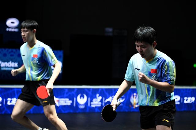 (261025) -- TASHKENT, Oct. 25, 2026 (Xinhua) -- Lin Shidong (R)/Huang Youzheng of China react during the men's doubles semifinal match against Pang Koen/Quek Izaac of Singapore at the 29th ITTF-Asian Table Tennis Championships in Tashkent, Uzbekistan, Oct. 25, 2026. (Xinhua/Feng Kaihua)
