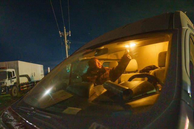 (261025) -- BAQEN, Oct. 25, 2026 (Xinhua) -- Du Guoping prepares to rest inside a vehicle after a full day's work at a temporary shelter in Maru Township of Baqen County, Nagqu City, southwest China's Xizang Autonomous Region, Oct. 24, 2026. After a 7.0-magnitude earthquake struck Baqen County in Nagqu, southwest China's Xizang Autonomous Region, on Thursday, Du Guoping, owner of a dumpling restaurant in Xigaze, postponed the opening of his two new restaurants and headed to the disaster zone with his staff.
  "It took only about 10 minutes to make the decision that we would go to Baqen and cook dumplings for earthquake-affected residents," Du said.
  The team loaded more than 1,500 kilograms of dumplings onto vehicles and set off from Xigaze at midnight on the night of the earthquake. 
  Upon arrival, Du and his staff set up cooking equipment and prepared dumplings for rescue workers and affected residents.
"Make sure everyone gets enough dumplings, and give children a couple more," Du kept telling his staff.
  Du and his staff did not eat any of the dumplings themselves. After a full day of cooking, they had some instant noodles -- their only meal of the day. At night, the six team members of Du squeezed into two vehicles to rest.
  "We will cook all the dumplings we brought," Du said. "We feel honored to be able to contribute in our own way." (Xinhua/Tenzin Nyida)