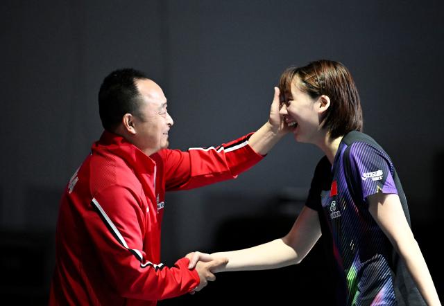 (261025) -- TASHKENT, Oct. 25, 2026 (Xinhua) -- Chen Yi (R) of China celebrates with her coach Li Dacheng after the women's singles final against Harimoto Miwa of Japan at the 29th ITTF-Asian Table Tennis Championships in Tashkent, Uzbekistan, Oct. 25, 2026. (Xinhua/Feng Kaihua)