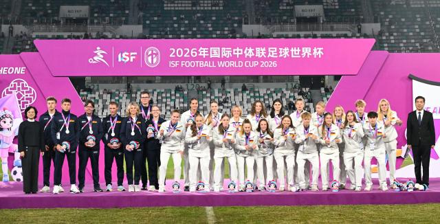 (261025) -- SUZHOU, Oct. 25, 2026 (Xinhua) -- Women's group 2nd-placed members of Germany react during the awarding ceremony at the 2026 International School Sport Federation (ISF) Football World Cup in Suzhou, east China's Jiangsu Province, Oct. 25, 2026. (Photo by Yang Suping/Xinhua)