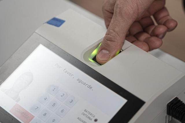 (261025) -- SAO PAULO, Oct. 25, 2026 (Xinhua) -- A voter verifies his identity at a polling station during the second round of Brazil's 2026 presidential election in Sao Paulo, Brazil, on Oct. 25, 2026. Brazil's Supreme Federal Court extends voting in presidential runoff by two hours. (Photo by Paulo Lopes/Xinhua)