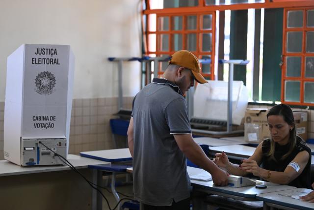 (261025) -- BRASILIA, Oct. 25, 2026 (Xinhua) -- A voter verifies his identity at a polling station during the second round of Brazil's 2026 presidential election in Brasilia, Brazil, on Oct. 25, 2026. Brazil's Supreme Federal Court extends voting in presidential runoff by two hours. (Photo by Lucio Tavora/Xinhua)