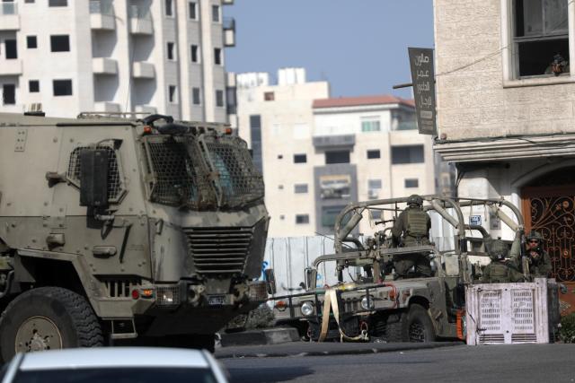 (261025) -- HEBRON, Oct. 25, 2026 (Xinhua) -- Israeli military vehicles patrol during a military operation in the West Bank city of Hebron, on Oct. 25, 2026. Israeli military operations continue in Hebron for the third consecutive day, amid ongoing closures and military movements. (Photo by Mamoun Wazwaz/Xinhua)