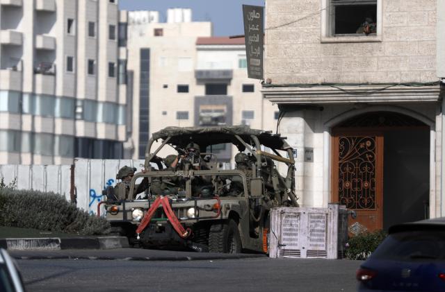 (261025) -- HEBRON, Oct. 25, 2026 (Xinhua) -- An Israeli military vehicle patrols during a military operation in the West Bank city of Hebron, on Oct. 25, 2026. Israeli military operations continue in Hebron for the third consecutive day, amid ongoing closures and military movements. (Photo by Mamoun Wazwaz/Xinhua)
