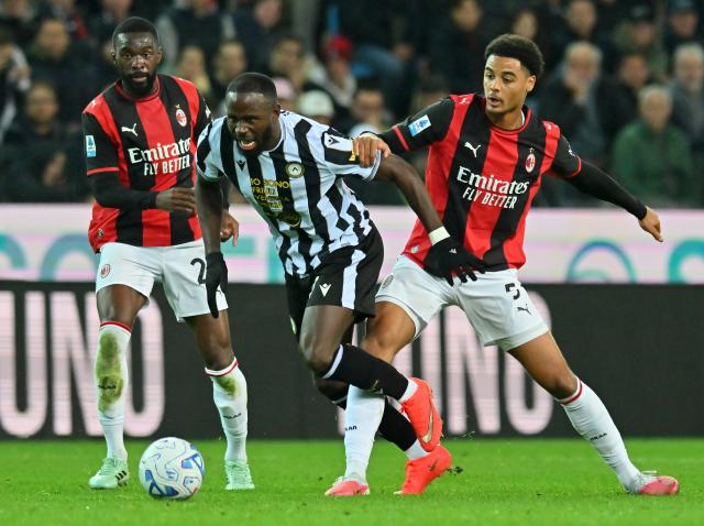 (261026) -- UDINE, Oct. 26, 2026 (Xinhua) -- AC Milan's Fikayo Tomori (L) and Koni De Winter (R) vie with Udinese's Keinan Davis during a Serie A football match between Udinese and AC Milan in Udine, Italy, Oct. 25, 2026. (Photo by Diego Petrussi/Xinhua)