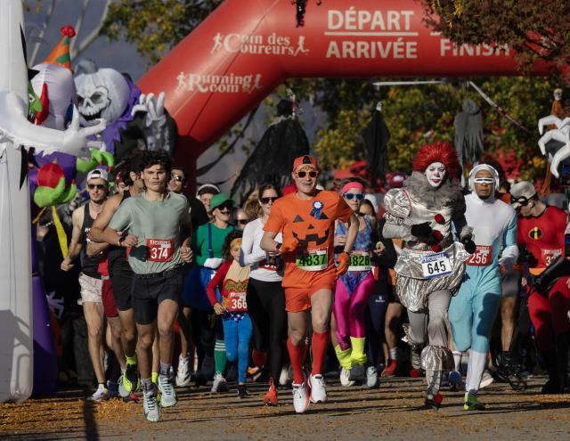 (261026) -- HAMILTON, Oct. 26, 2026 (Xinhua) -- Dressed-up participants take part in the 2026 Halloween Races in Hamilton, Ontario, Canada, on Oct. 25, 2026. About 500 participants took part in this annual event on Sunday, competing in either 1 km, 5 km or 10 km race. (Photo by Zou Zheng/Xinhua)