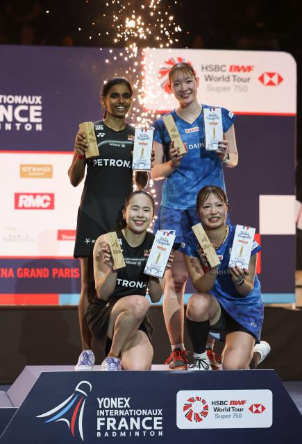 (261026) -- PARIS, Oct. 26, 2026 (Xinhua) -- Fukushima Yuki (R, front)/Matsumoto Mayu (R, top) of Japan and Pearly Tan/Thinaah Muralitharan (L, top) of Malaysia pose at the awarding ceremony after their women's doubles final match at the French Open badminton tournament in Paris, France, Oct. 25, 2026. (Xinhua/Wu Huiwo)