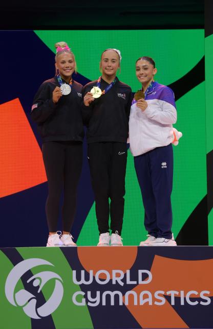 (261026) -- ROTTERDAM, Oct. 26, 2026 (Xinhua) -- Gold medalist Claire Pease (C), silver medalist Reese Esponda (L) of the United States and bronze medalist Maiana Prat of France pose for photos during the awarding ceremony for the women's floor exercise event at the Artistic Gymnastics World Championships 2026 in Rotterdam, the Netherlands, Oct. 25, 2026. (Xinhua/Weng Xinyang)