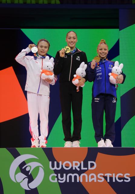 (261026) -- ROTTERDAM, Oct. 26, 2026 (Xinhua) -- Gold medalist Kaylia Nemour (C) of Algeria, silver medalist Zhang Qingying (L) of China and bronze medalist Flavia Saraiva of Brazil pose for a group photo at the awarding ceremony for the women's balance beam event at the Artistic Gymnastics World Championships 2026 in Rotterdam, the Netherlands, Oct. 25, 2026. (Xinhua/Weng Xinyang)