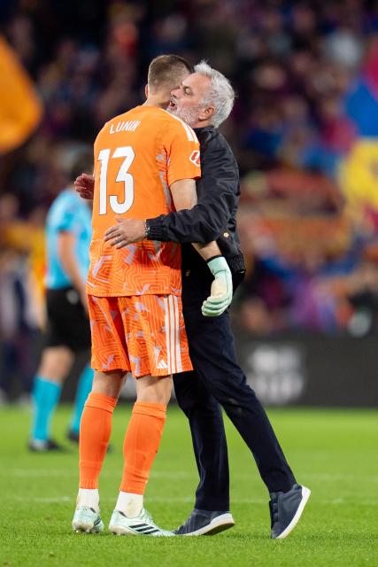 (261026) -- BARCELONA, Oct. 26, 2026 (Xinhua) -- Jose Mourinho (R), head coach of Real Madrid CF celebrates victory with Andriy Lunin after the La Liga football match between FC Barcelona and Real Madrid CF in Barcelona, Spain, on Oct. 25, 2026. (Photo by Joan Gosa/Xinhua)