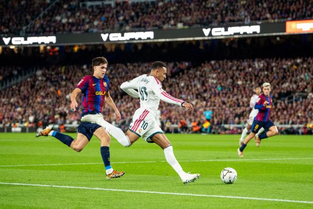 (261026) -- BARCELONA, Oct. 26, 2026 (Xinhua) -- FC Barcelona's player Pau Cubarsi (L) vies with Real Madrid CF's player Kylian Mbappe during the La Liga football match between FC Barcelona and Real Madrid CF in Barcelona, Spain, on Oct. 25, 2026. (Photo by Joan Gosa/Xinhua)