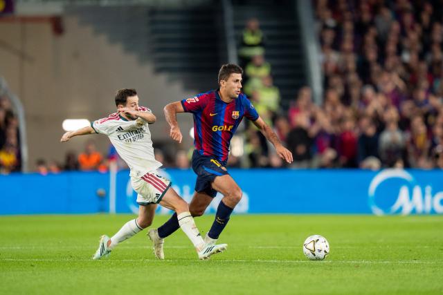 (261026) -- BARCELONA, Oct. 26, 2026 (Xinhua) -- FC Barcelona's player Rodri (R) vies with Real Madrid CF's player Bernardo Silva during the La Liga football match between FC Barcelona and Real Madrid CF in Barcelona, Spain, on Oct. 25, 2026. (Photo by Joan Gosa/Xinhua)