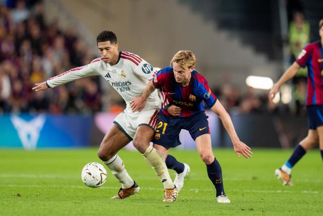 (261026) -- BARCELONA, Oct. 26, 2026 (Xinhua) -- FC Barcelona's player Frenkie de Jong (R) vies with Real Madrid CF's player Jude Bellingham during the La Liga football match between FC Barcelona and Real Madrid CF in Barcelona, Spain, on Oct. 25, 2026. (Photo by Joan Gosa/Xinhua)