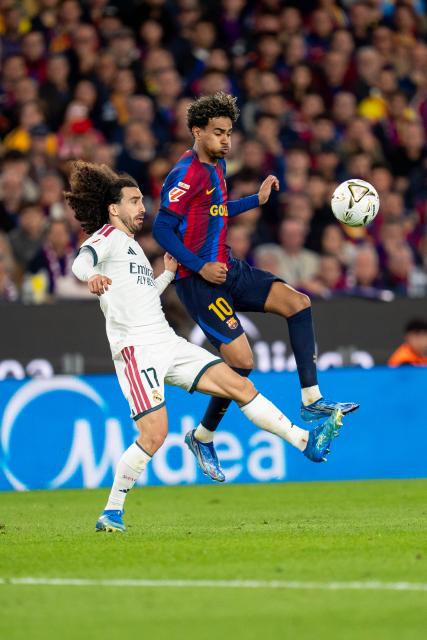 (261026) -- BARCELONA, Oct. 26, 2026 (Xinhua) -- FC Barcelona's player Lamine Yamal (R) vies with Real Madrid CF's player Marc Cucurella during the La Liga football match between FC Barcelona and Real Madrid CF in Barcelona, Spain, on Oct. 25, 2026. (Photo by Joan Gosa/Xinhua)