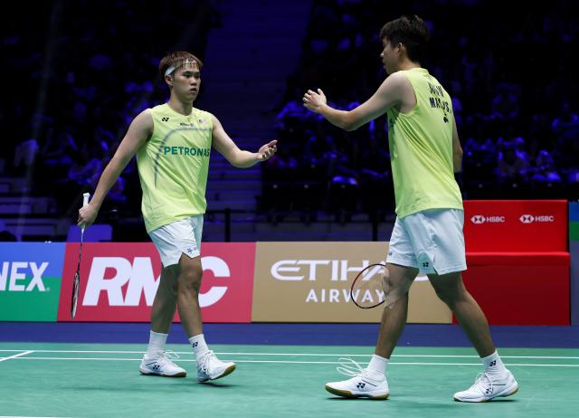(261026) -- PARIS, Oct. 26, 2026 (Xinhua) -- Man Wei Chong/Tee Kai Wun (L) of Malaysia react during the men's doubles final match between Man Wei Chong/Tee Kai Wun of Malaysia and Goh Sze Fei/Nur Izzuddin of Malaysia at the French Open badminton tournament in Paris, France, Oct. 25, 2026. (Xinhua/Wu Huiwo)