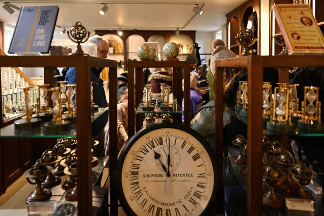 (261026) -- LONDON, Oct. 26, 2026 (Xinhua) -- People visit a souvenir shop at the Royal Observatory in Greenwich, London, Britain, on Oct. 25, 2026. The Royal Observatory in Greenwich was founded in 1675 to improve navigation at sea through astronomical observations and help ships determine their longitude. As the home of Greenwich Mean Time, it holds an important place in the history of astronomy, precision timekeeping and navigation. In 1884, the meridian passing through the observatory was adopted as the international Prime Meridian, establishing a common reference for measuring longitude worldwide. This historic line is still marked at the observatory today. (Xinhua/Li Mangmang)