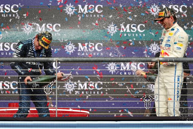 (261026) -- AUSTIN, Oct. 26, 2026 (Xinhua) -- Race winner Mercedes' Kimi Antonelli (L) of Italy and 3rd-placed Red Bull's Max Verstappen of the Netherlands celebrate on the podium after the Formula One United States Grand Prix, in Austin, Texas, the United States, Oct. 25, 2026. (Photo by Song Haiyuan/Xinhua)
