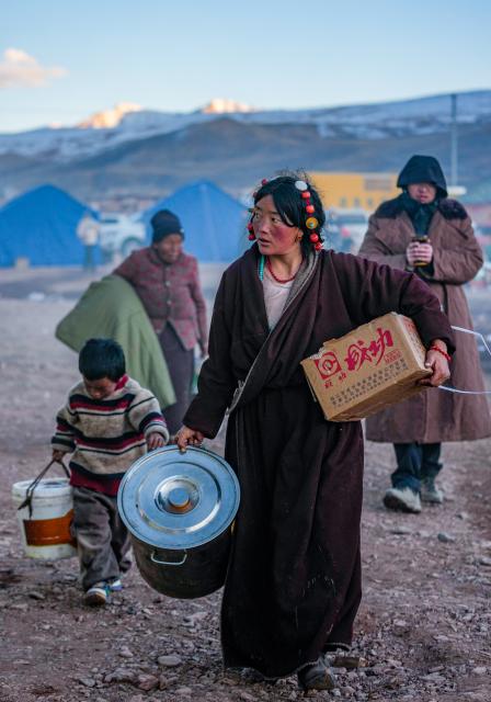 (261026) -- BAQEN, Oct. 26, 2026 (Xinhua) -- Residents carry daily necessities in a quake-hit village in Maru Township of Baqen County, Nagqu City, southwest China's Xizang Autonomous Region, Oct. 25, 2026.
  The first 60 prefabricated housing units in the earthquake zone were completed at 2:10 a.m. on Oct. 25, and electricity was connected to the units by 8 p.m. on the same day. (Xinhua/Tenzin Nyida)