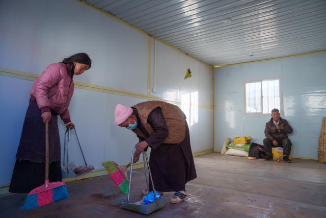 (261026) -- BAQEN, Oct. 26, 2026 (Xinhua) -- Residents clean a prefabricated house at a resettlement site of a quake-hit village in Maru Township of Baqen County, Nagqu City, southwest China's Xizang Autonomous Region, Oct. 25, 2026.
  The first 60 prefabricated housing units in the earthquake zone were completed at 2:10 a.m. on Oct. 25, and electricity was connected to the units by 8 p.m. on the same day. (Xinhua/Tenzin Nyida)