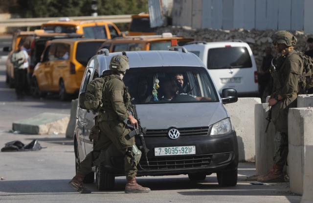 (261026) -- HEBRON, Oct. 26, 2026 (Xinhua) -- A Palestinian drives through strict security checks at an Israeli checkpoint in the West Bank city of Hebron, on Oct. 26, 2026. Israeli forces launched a military operation in Hebron on Friday night. (Photo by Mamoun Wazwaz/Xinhua)